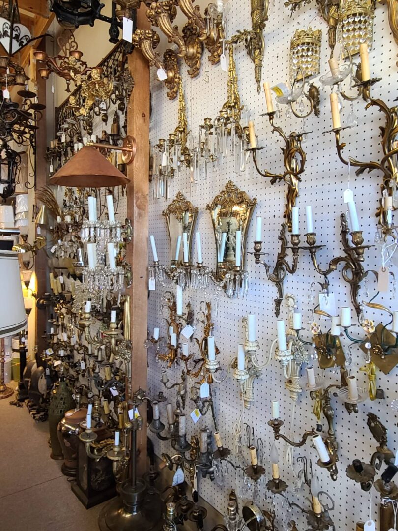 Antique brass wall sconces and mirrors display