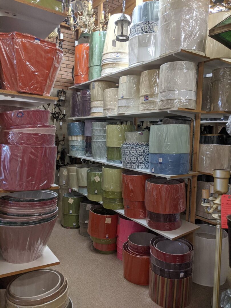 Assorted colorful lampshades displayed on racks